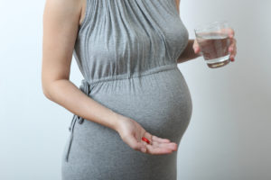 pregnant woman taking prenatal vitamins