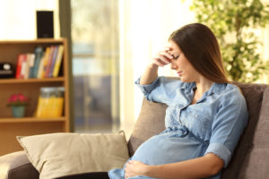 pregnant woman with anxiety on couch