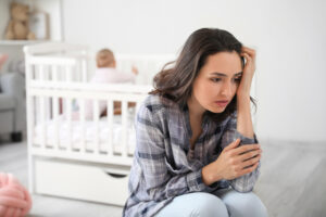 new mom experiencing PPD in baby's nursery 