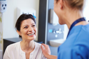 doctor comforting female patient in medical room