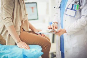 doctor and patient discussing something near exam table