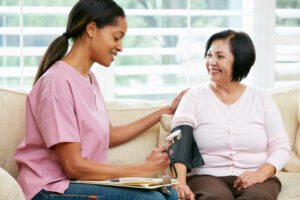 middle aged woman at gynecology appointment getting blood pressure taken