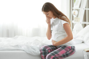 Young pregnant woman suffering from morning sickness