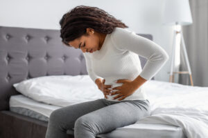 woman suffering from strong abdominal pain