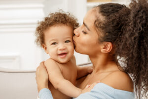 Woman kissing baby on the cheek