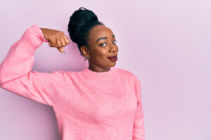 Strong woman in pink sweater. 